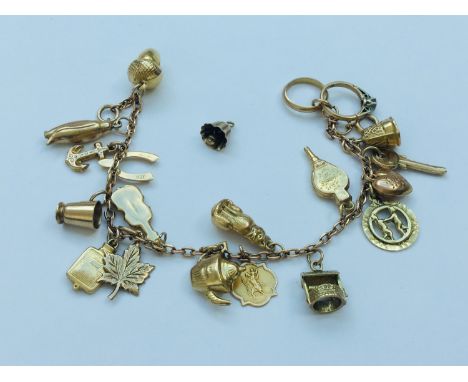 A 9ct gold charm bracelet with 19 x gold charms (one charm loose) including a penguin, an acorn, a teapot and a wishing well,