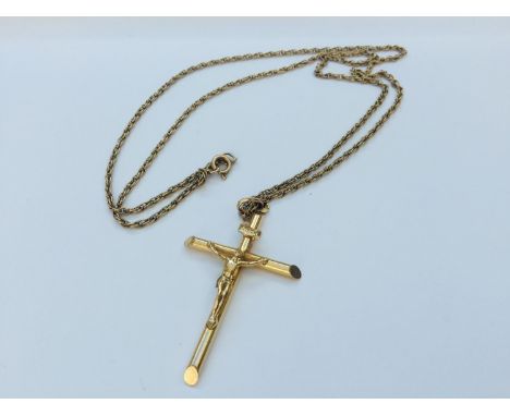 A 9ct yellow gold crucifix and chain, measuring 24 inches, weighing 8.7 grams. 