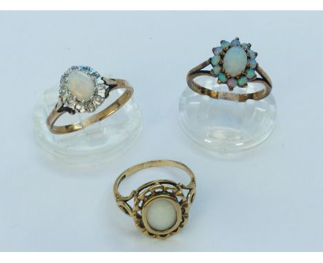 Three 9ct yellow gold opal dress rings, total weight 7.5 grams. 
