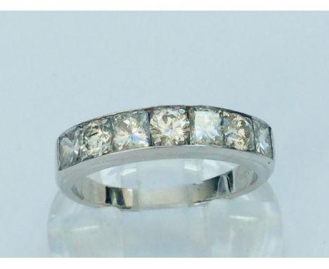 A ladies 18ct white gold diamond ring, set with four princess cut diamonds and three round brilliant cut diamonds, estimated 