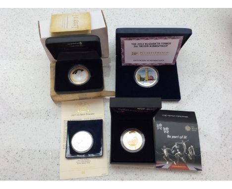 A 2007 Britannia Fine Silver One Ounce coin, 2012 NZ 'The Hobbit' $1 Silver coin, 2012 London Olympic Gold Plated £5 Silver P