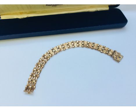 A 9ct gold articulated bracelet in blue fitted box weighing 14.8 grams. 
