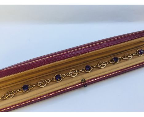 A 9ct yellow gold bracelet set with 5 x round faceted amethysts in a claw setting, weighs 7.2 grams, measures 7 inches in len