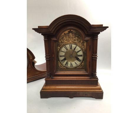 A 20th century walnut mantel clock, with domed top, arched dial with applied gilt scrolls and stylised male face, white paint