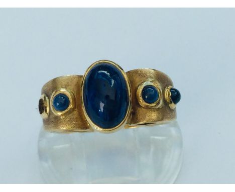 An 18ct yellow gold dress ring, set with cabochon sapphires (end sapphire missing) ring weighs 6.4 grams, finger size P. 