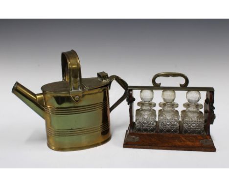 Oak tantalus containing glass bottles, unusually small in size 22 x 19cm, together with a brass watering can (2)