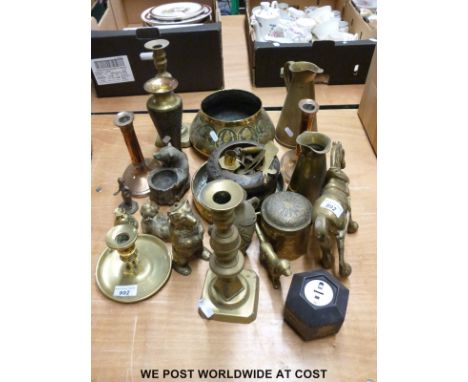 A quantity of brassware to include candlesticks, vases, a dog inkwell, bowls and an ornate caddy