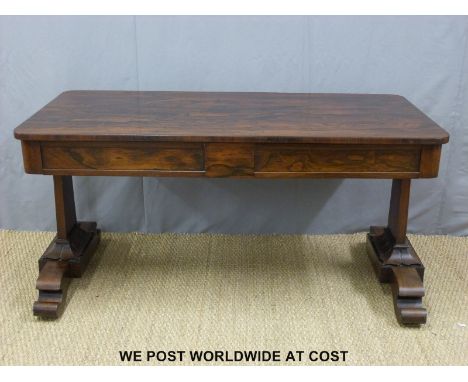 A 19thC rosewood library or sofa table with two straight drawers on two tapering supports with moulded detail and raised on f