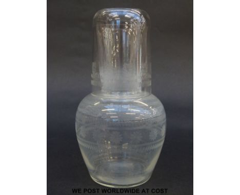 A clear glass decanter and up with engraved decoration, 17cm tall. 