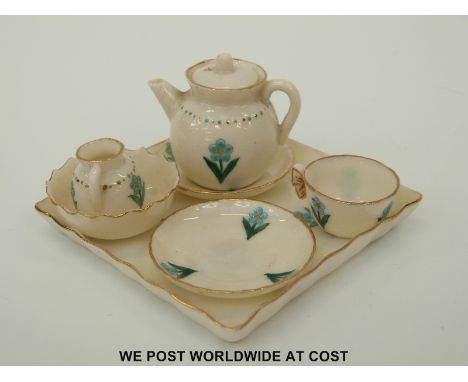 A miniature WH Goss tea set in forget me not pattern with teapot, milk jug, tea cup, two saucers and a tray