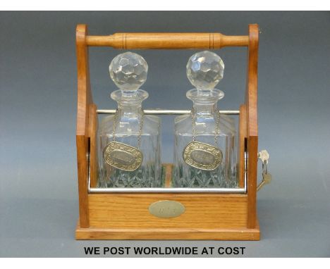 An oak two-bottle tantalus (W28cm)
