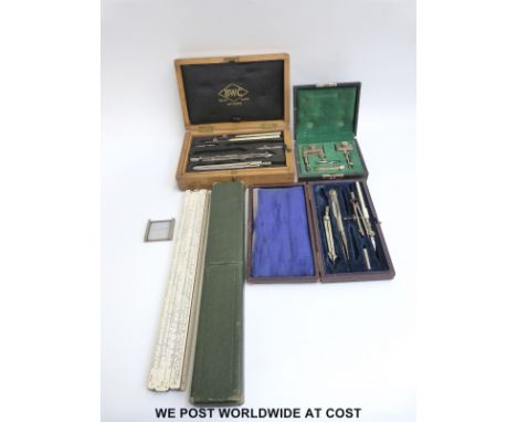 A slide rule, compass set and other boxed technical drawing implements