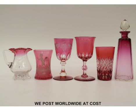 Six pieces of cranberry glassware comprising three flash overlaid cut glasses, Mary Gregory jug, decanter and pedestal jug, l