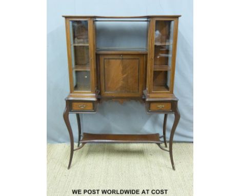 A 19thC / 20thC mahogany breakfront bureau cabinet, the central panel falling forward to form a writing slope, with inkwells 