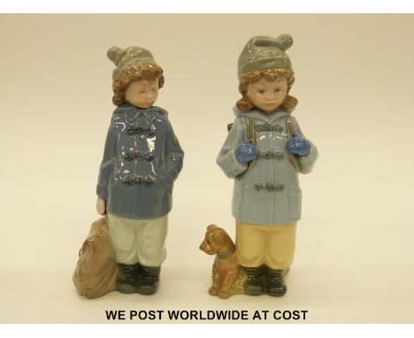 Two Nao figures of children wearing winter coats