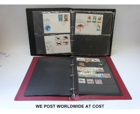 A stockbook of Rhodesia and South Africa stamps and an album of Rhodesia first day covers