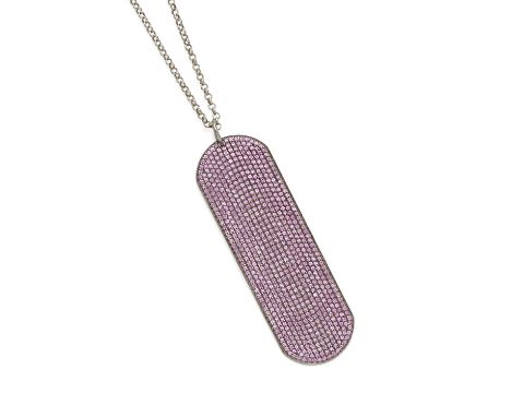 A ruby dog tag pendant necklace mounted in blackened silver; necklace length: 24in.Lot to be sold without reserve.