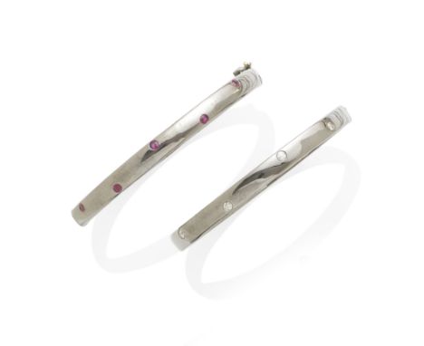 A Ruby bangle together with a diamond bangle mounted in silver; bracelet lengths: 7in.Lot to be sold without reserve.