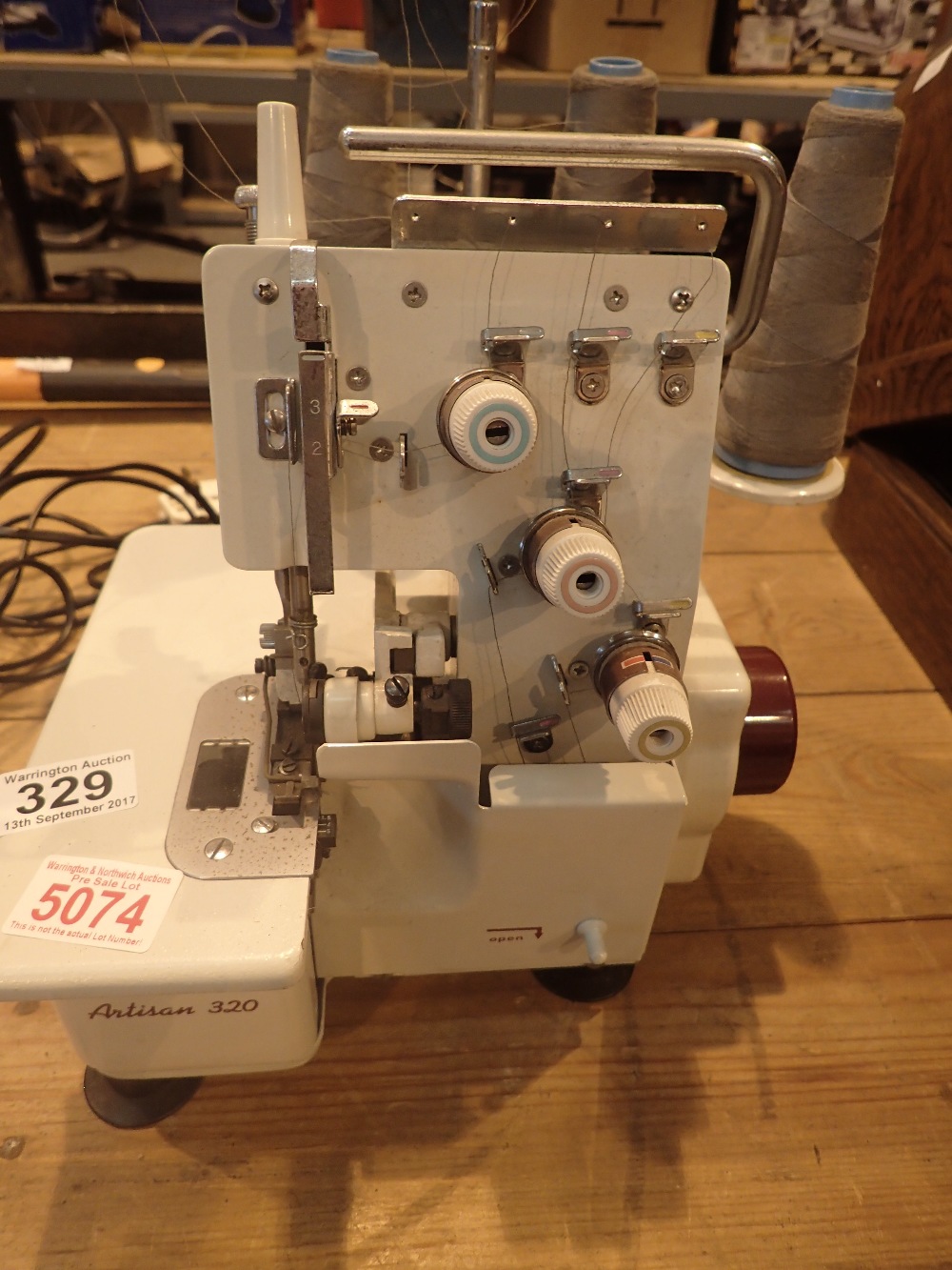Artisan 320 overlocker sewing machine with foot pedal control