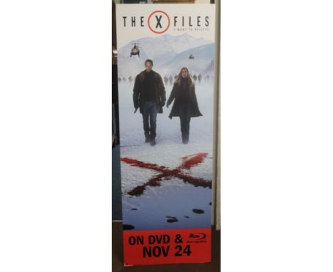 A LARGE X-FILES CARDBOARD CUT OUT ADVERTISING ITEM, together with four mounted collectable X-Files Film cells.