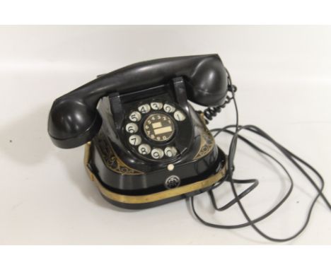 A VINTAGE BELGIUM TELEPHONE, black painted metal body with gilt decoration and bakelite hand set. Converted for modern use