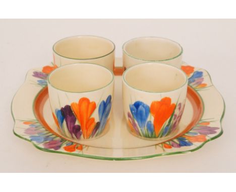 Clarice Cliff - Crocus - An egg cup set circa 1932 with a Leda shape plate and four egg cups all hand painted with Crocus spr