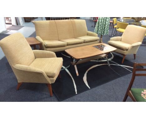 Parker Knoll - A three-piece lounge suite comprising sofa and a pair of armchairs, each raised to splayed beech legs and upho