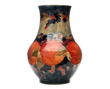 William Moorcroft - A vase of shouldered ovoid form decorated in the Pomegranate pattern with a band of fruit and foliage to 