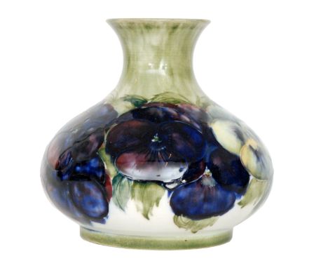 William Moorcroft - A Pansy pattern vase of compressed form with a flared collar neck decorated with a band of flowers and fo