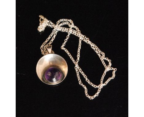 Nils Erik From - A 1960s Danish Sterling silver and amethyst pendant of circular concave design, inset with a cabochon amethy