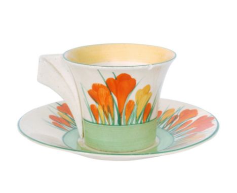 Clarice Cliff - Sungleam - A Daffodil shape cup and saucer circa 1932 hand painted with tonal orange and yellow crocus sprays