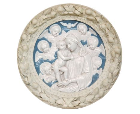 In the manner of Della Robbia - An early 20th Century circular plaque with a ceramic roundel in blue and white depicting the 