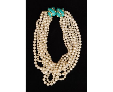 Kenneth Jay Lane - An eight row simulated pearl necklace with double faux turquoise and pearl shell clasp, lozenge mark to re
