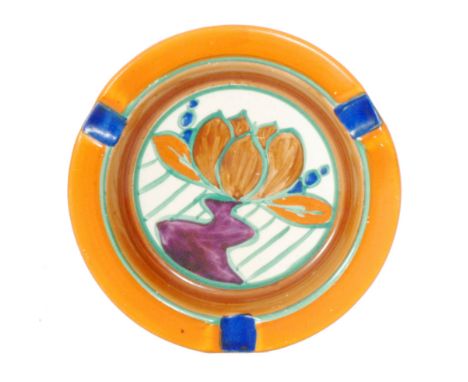 Clarice Cliff - Brown Lily - A circular ashtray circa 1929 hand painted with a stylised flower and foliage with orange, green