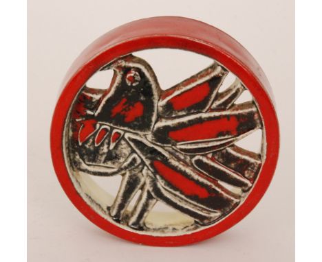 Lisa Larson - Gustavsberg - A circular wall plaque relief moulded and pierced with a stylised open winged bird in a tonal red