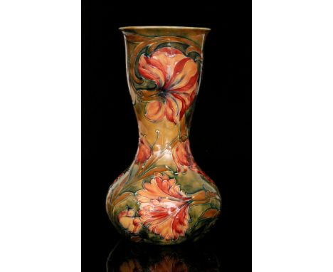 William Moorcroft - A vase of bulbous form with a flared collar neck decorated in the Spanish pattern with tubelined flowers 