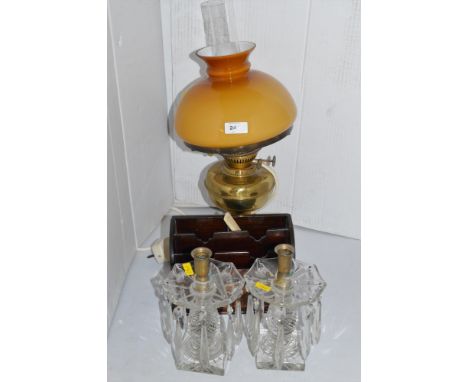A brass duplex oil lamp with yellow glass shade; a pair of cut glass table lustre candle sticks; and an Edwardian inlaid maho