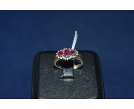 A ruby and diamond ring, the three oval rubies surrounded by a diamond bezel, on 9ct yellow gold shank, ring size O.