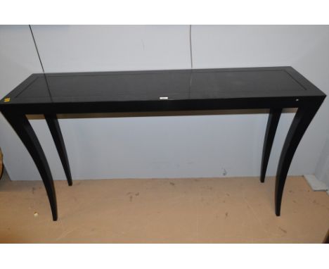 A modern black console table raised on shaped square tapering legs, 153 x 40 x 87cms high.
