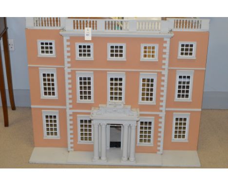 A three storey unfurnished Newby Hall dolls house; together with a collector's book.