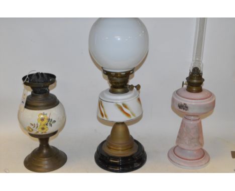 Three oil lamps, to include: duplex brass lamp with porcelain reservoir; brass lamp with white glass reservoir and white glas
