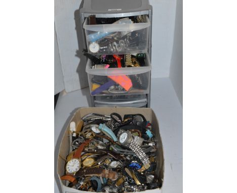 A small set of plastic storage drawers filled with assorted watches; together with another box of assorted watches, makers to