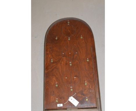 An antique bagatelle board with plaque 'Corinthian 15', with balls.