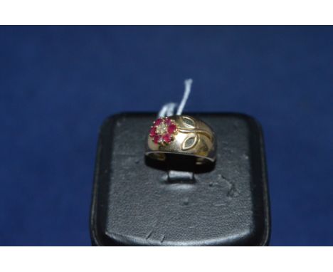 A ruby and sapphire ring, in flower setting, on 9ct yellow gold shank, ring size M.
