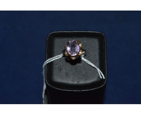 Amethyst ring, in wavy mount, on 9ct yellow gold shank, ring size O.