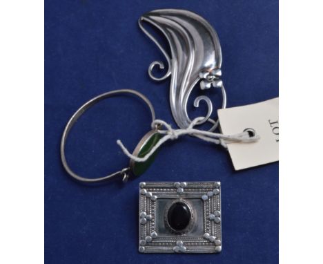 A Nils Erik From sterling silver bangle centred by green stone; A Janina buckle: and a silver coloured brooch.