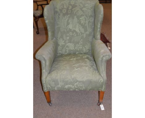 A late 19th Century wing armchair, upholstered in modern green patterned material, raised on mahogany square tapering front l
