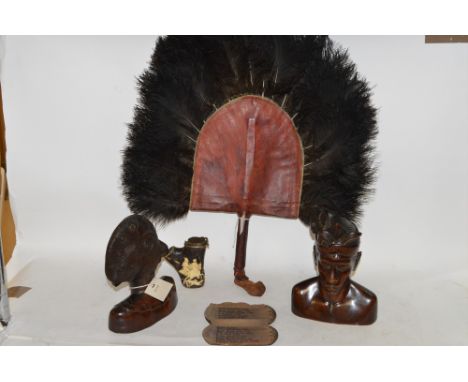 A pair of Bali bust carvings; a carved pipe; stobwassa type case; and an Ostrich feather fan.