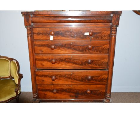 A Victorian mahogany scotch chest of six graduating drawers flanked by turned pilasters, raised on turned feet, 120cms wide.