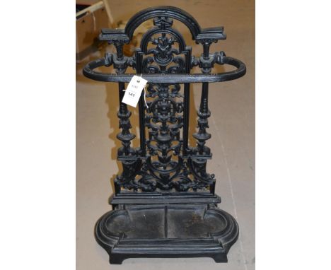A reproduction Victorian style cast iron stick stand, with shaped removable drip tray, 40cms wide.